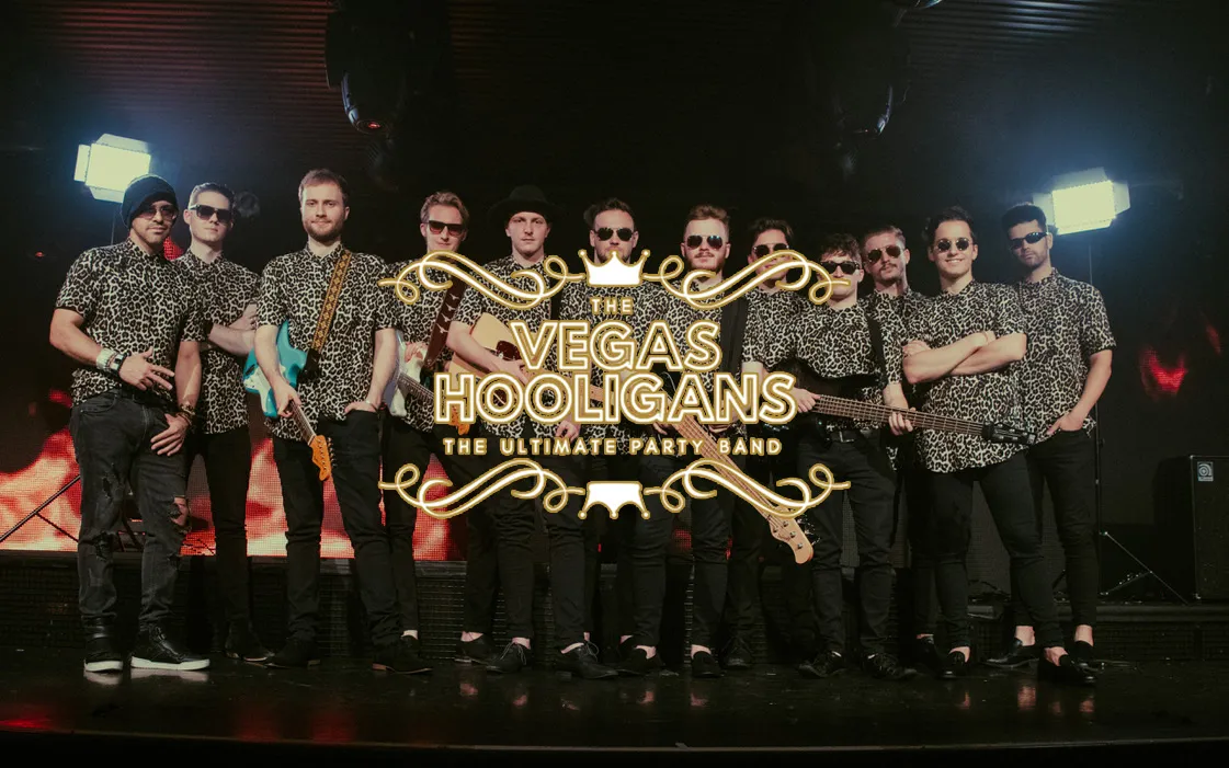 Group photo of the full musical collective on stage